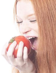 Choosing Bible Foods- Woman biting a tomato