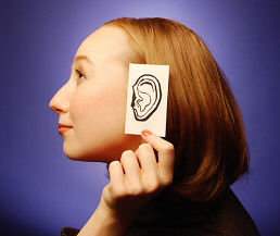 How to Hear God's Voice - Woman holding paper ear How to Hear God's Voice - Woman holding paper ear