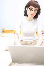 Woman using the Bible study online Blog on laptop